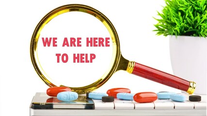 Animated inscription WE ARE HERE TO HELP through a magnifying glass on a white background, standing on a calculator with tablets
