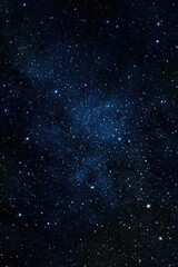 Fototapeta premium Dark blue night sky densely populated with countless stars, a brighter band of the Milky Way visible