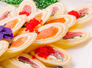 Delicious pancakes sushi rolls displayed elegantly on a platter with vibrant toppings