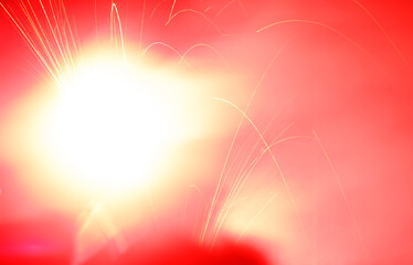 A red background with a white sun in the center