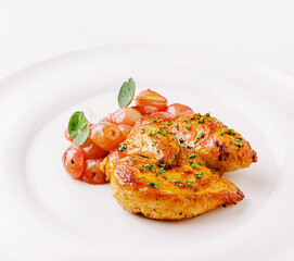 Delicious grilled chicken served with roasted cherry tomatoes and herbs