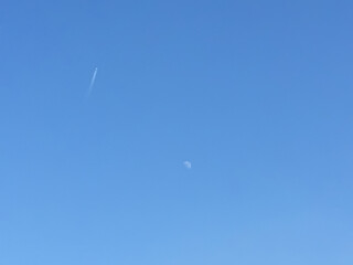 Clouds and Moon in the Blue Sky