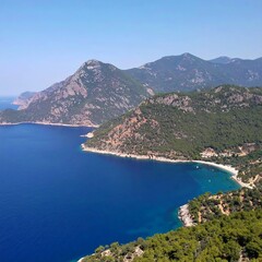 Fototapeta premium Coastal view of a serene bay nestled between verdant mountains under a clear blue sky
