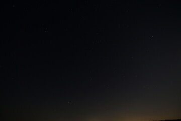 Night sky full of shining stars above the peaceful summer nature. A stunning view of the Milky Way...
