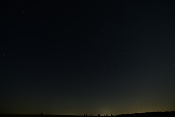 Night sky full of shining stars above the peaceful summer nature. A stunning view of the Milky Way...