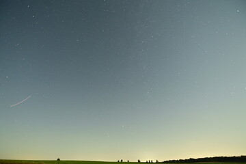 Night sky full of shining stars above the peaceful summer nature. A stunning view of the Milky Way...