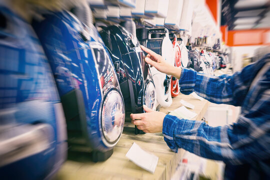 Woman and vacuum cleaner in store