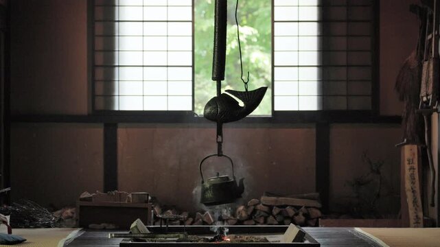 Traditional Hearth "Irori" in the Living Room of a Wooden House. Iron Kettle is Hung on a Pothook "Jizaikagi" to Boil Water | Tateshina, Nagano, Japan