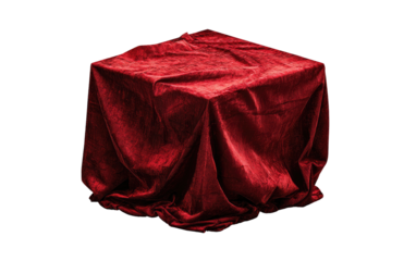 Red velvet draped cube on black background