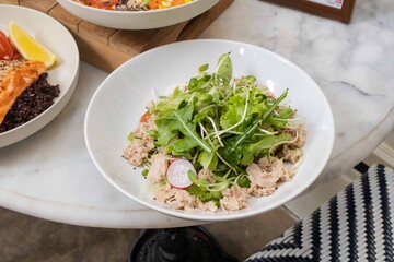 Fresh tuna salad bowl with leafy greens
