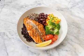 Grilled salmon grain bowl with vegetables and lemon
