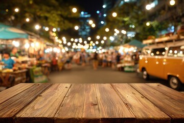Wooden table top at night market. Blurry background of people, stalls, and streetlights