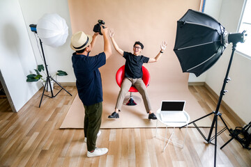Photographer Captures Seated Model During Creative Studio Shoot