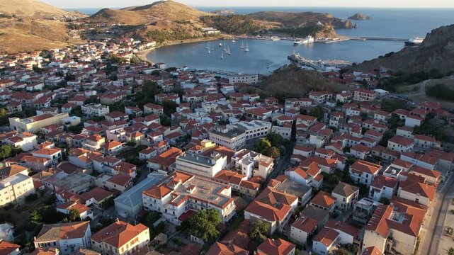 Aerial Dolly in Myrina Coastal Capital of Limnos Greece, Drone View of Traditional Houses and Port