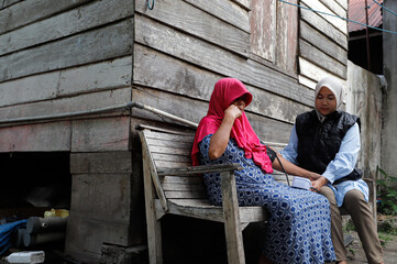 Female Health Worker Checks Blood Pressure of Elderly Woman in Rural Area During Medical Visit