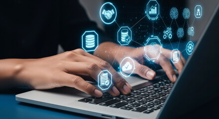 Person's hands typing on a laptop keyboard with a digital overlay of interconnected business and technology icons floating above, representing data management and network connections