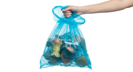 Hand holding blue garbage bag with waste isolated on white background