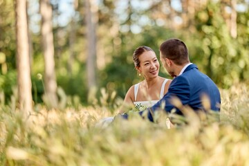Newlywed Couple Sitting in a Field Enjoying a Beautiful Moment Together