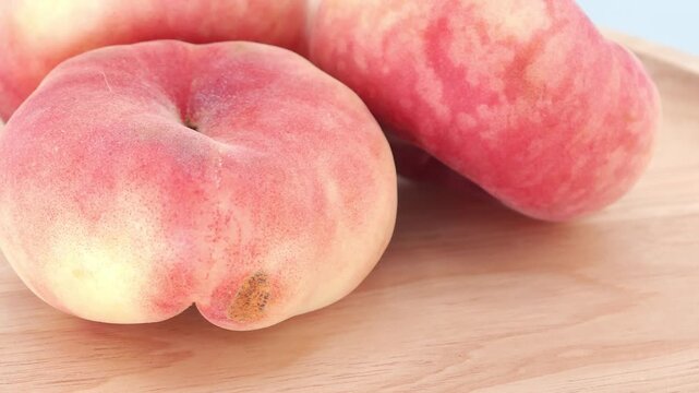 Fresh peaches on a wooden background. Flat peach donut shape