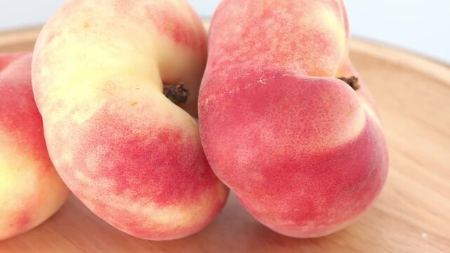 Fresh peaches on a wooden background. Flat peach donut shape