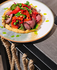Beautifully presented grilled beef dish with vegetables on a plate