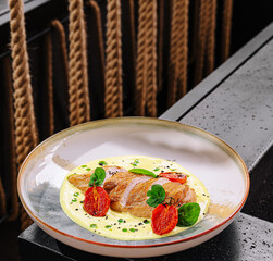 Delicious chicken dish served with vibrant cherry tomatoes at a seaside restaurant