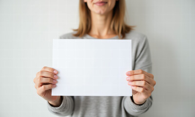 Fototapeta premium Woman Holding Blank White Paper Sign