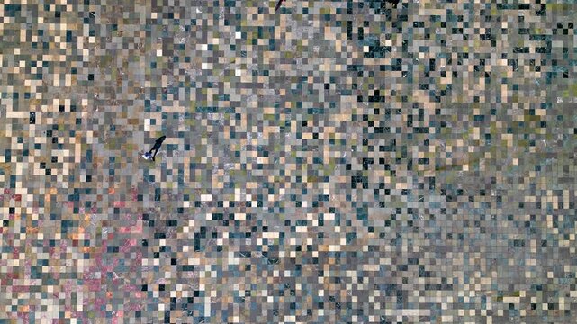 Drone view looking directly downward on Skanderbeg Square in Tirana, showing patterns in the tiles and pedestrians crossing the area
