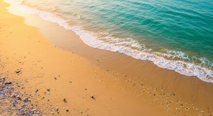 Golden beach meets turquoise sea.