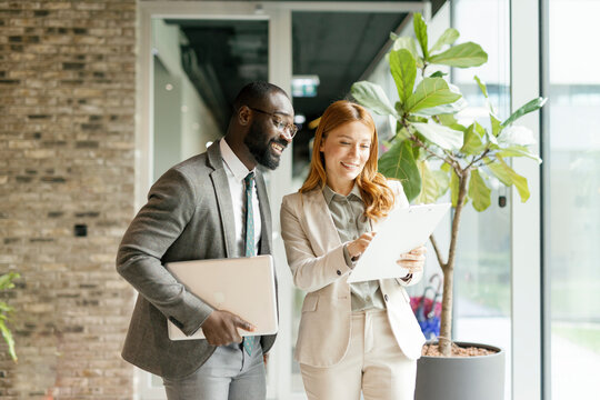 Business colleagues discussing documents in modern office environment