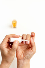 Close-up of hands with nourishing oil or cosmetic liquid