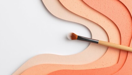 A makeup brush rests on undulating, peach-toned paper waves against a white background, creating a minimalist, cosmetic-themed design