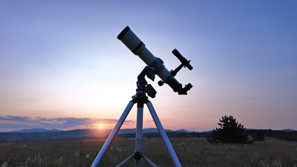 Preparing for night sky observing with a astronomical telescope just before sunset in the...