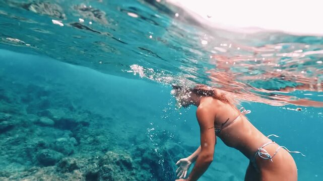 Young woman free diving in tropical ocean montage