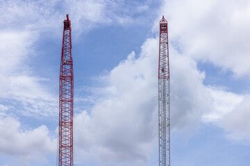 Crawler crane on blue sky white clouds background, Real estate industry. Red crawler crane use reel lift up equipment in construction site. Crane for rent. Crane dealership for construction business.