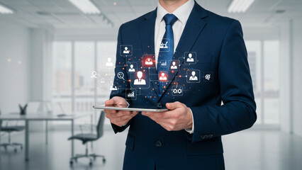Businessman using a digital tablet for innovative human resources management and recruitment, showing a network of candidate profiles in a modern office