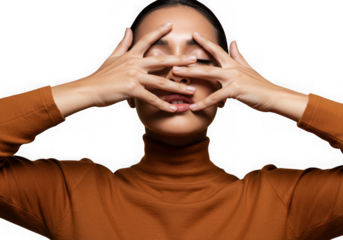 Woman hiding face with hands against dark background
