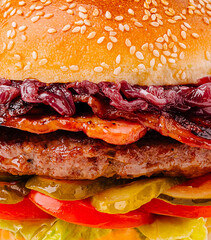 Delicious gourmet burger with fresh ingredients on a sesame seed bun