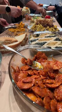 Sausage sliced in tomato sauce roasted by smoky eggplant dip tangy kashk is Persian appetizer concept in Iranian food gourmet recipe handmade party dining table family serving spicy delicious plate
