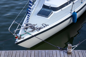 Close-up of mooring ropes securing a boat to the dock. Nautical detail symbolizing safety,...