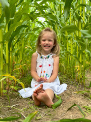 Little girl sitting in a corn fieldchild, 