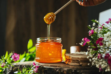 Natural organic honey in a glass jar, healthy sweet food. Natural food background.