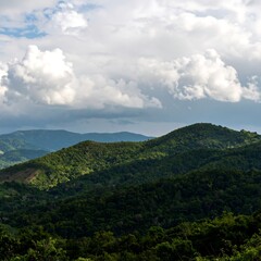 Lush green mountain range under a partly cloudy sky