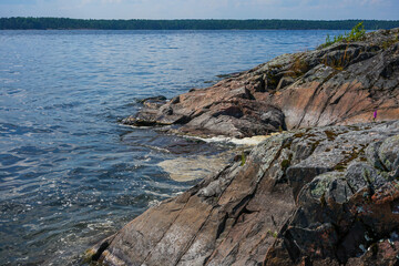 Rocky Shoreline on a Lake under a Blue Sky