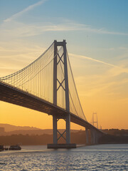Fototapeta premium Vasco Da Gama bridge over Tagus River against sky during sunset