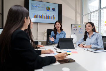 Businesswomen discussing charts and data on a meeting