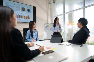 Asian businesswoman leading a meeting in a modern office
