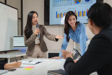 Asian businesswomen leading a presentation in a modern office
