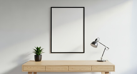 Fototapeta premium Blank vertical poster frame hanging on a white wall above a minimalist wooden desk. template mockup