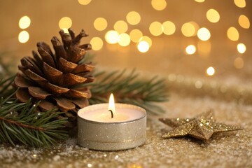 Golden Christmas Advent candle on a sparkling glitter background